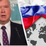 Екс-дипломат США Стівен Біґан на тлі прапора Росії та мапи світу