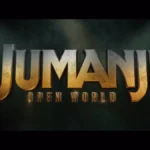 Золотий логотип Jumanji Open World на темному тлі з променями світла